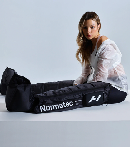 Woman sitting in Normatec Elite leg compression boots
